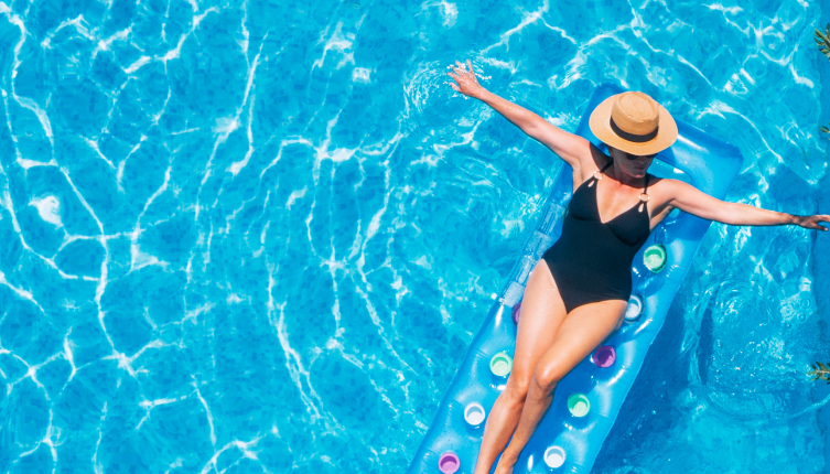 Woman- Relaxing on Inflatable Bed in a Swimming Pool